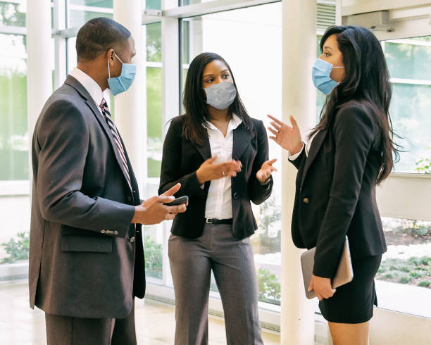 Businessman and businesswomen having a meeting wearing face masks. Businessman and businesswomen having a meeting wearing face masks.
